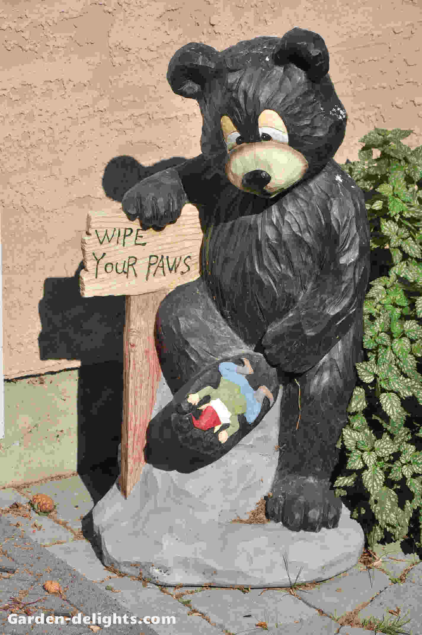  Bear garden statue with one foot up with garden gnome underneath his foot with a sign wipe your paws, outdoor wood bear statues, risen bear statues, black forest bear welcome statue, wipe your paws, bear garden, yard ornaments, garden sculptures, funny yard statues, unique ornaments.