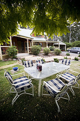 Outdoor Lawn Furniture, Outdoor furniture set on grass in front of house.