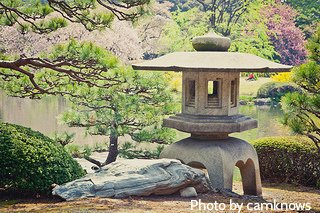 Japanese stone garden lantern with rock beside on ground overlooking pond,large garden lanterns,Japanese sushi style lanterns
