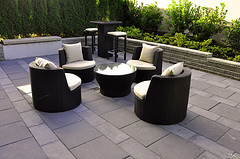 Outdoor furniture rugs, Brown Wicker patio furniture with coffee table and stand up bar with stools.