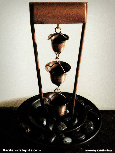  Tabletop copper rain chain water fountain with three bell cups hanging down from brass hanger into a ceramic bowl with black rocks, tabletop fountain ideas, copper tabletop fountain, best-selling tabletop fountains, unique tabletop fountains, tabletop waterfall.