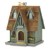 A cute Thatch Roof Chimney wood cottage birdhouse with a 2 1/8 inch x 2 7/8 inch door with a high peak roof, decorative birdhouse,, fancy birdhouses. 