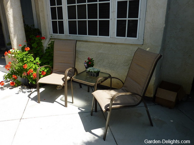 Brown three piece wrought iron patio set on patio, wrought iron patio furniture, refurbish wrought iron outdoor furniture.