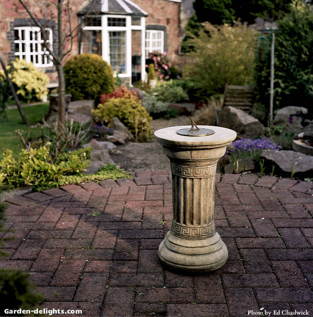  Sundial mounted on Greek stone pillar on Brickstone round patio in backyard garden decor, garden sundials for sale, stone garden sundials, Walmart, garden sundial on stand, sundial plinths.