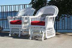 outdoor furniture tips, four piece Wicker patio furniture set in front of pool on patio.