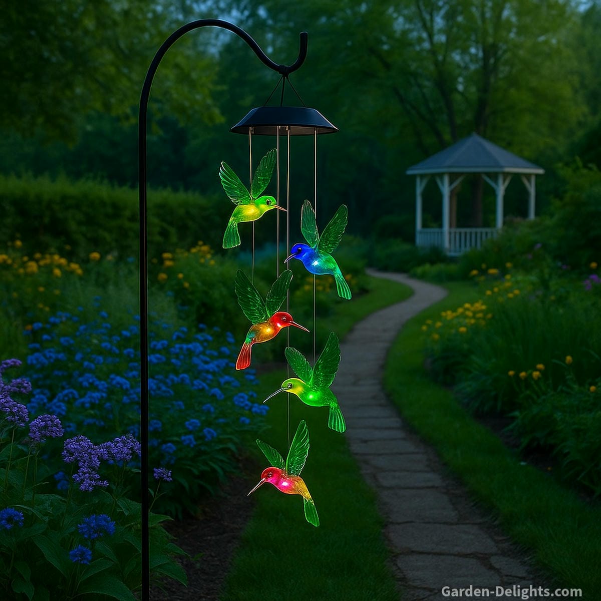 Hummingbird solar wind chimes with glowing LED lights in a blooming garden symbolizing joy, remembrance, and spiritual healing energy in Feng Shui outdoor décor