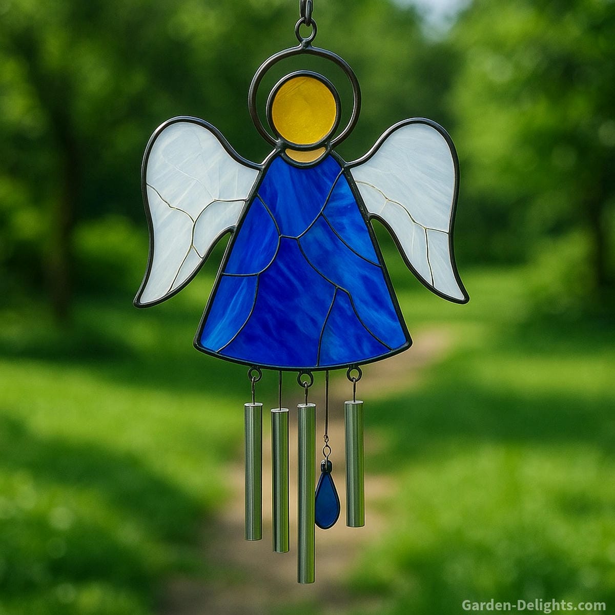Angel-shaped stained glass wind chime glowing in sunlight symbolizing remembrance, spiritual comfort, and emotional healing in a tranquil memorial garden or peaceful backyard sanctuary